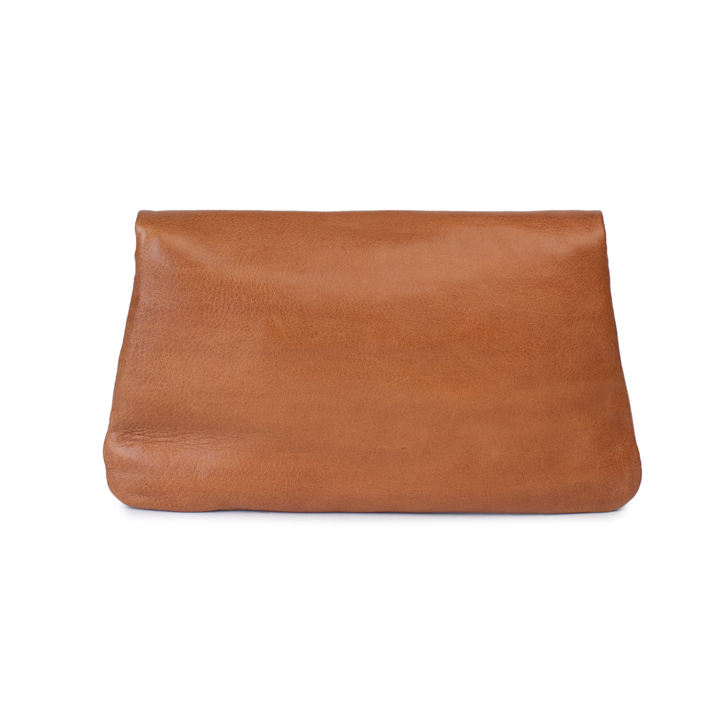 Front view of Quinn purse in tan leather, featuring a fold-over flap and a sleek, minimalist design.