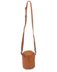 Bobbi cross body bag in tan leather with adjustable strap and front pocket for essentials.