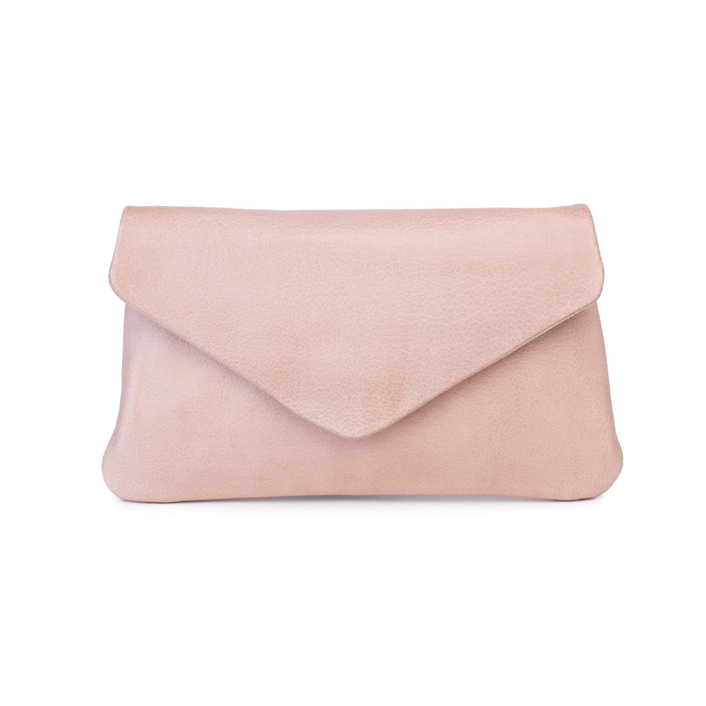 Quinn purse in soft blush pink leather with a fold-over flap design and minimalist silhouette.