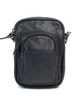 Mini camera bag in dark leather with zip closure and front pocket, featuring an adjustable strap for easy carrying.